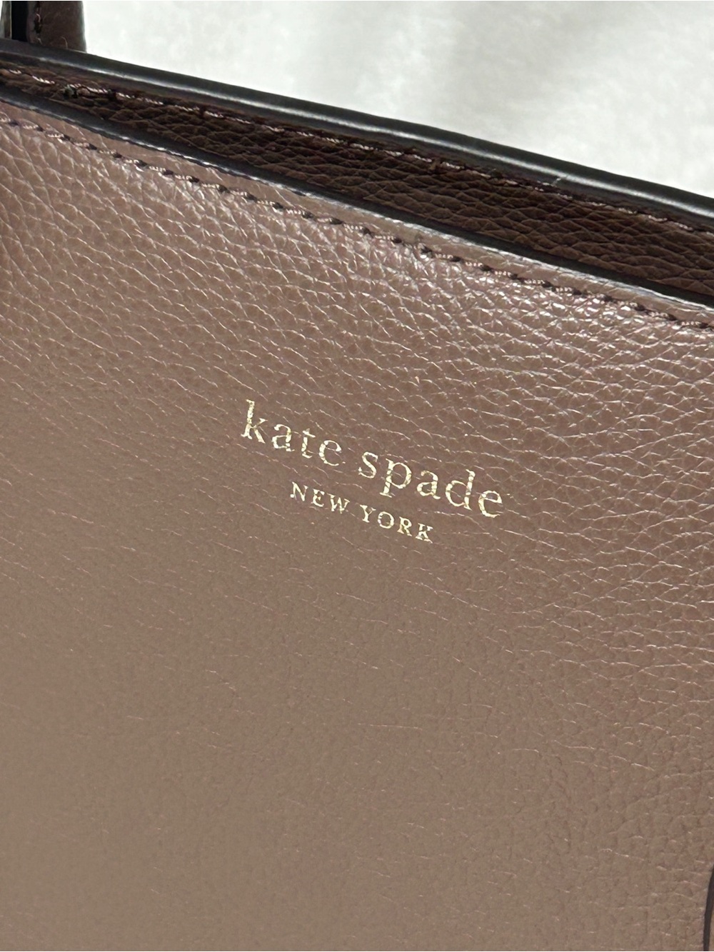 kate spade pebbled leather tote in taupe with gold logo
